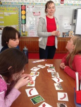 Jenn Davis, community compost coordinator, teaches 4th graders at Cambridge Elementary School about a closed loop food cycle, using pictures and arrows