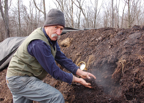 Farmer Richard Hudak, checking compost pile