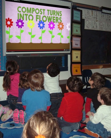 Students at Johnson Elementary School watch a training video about composting  